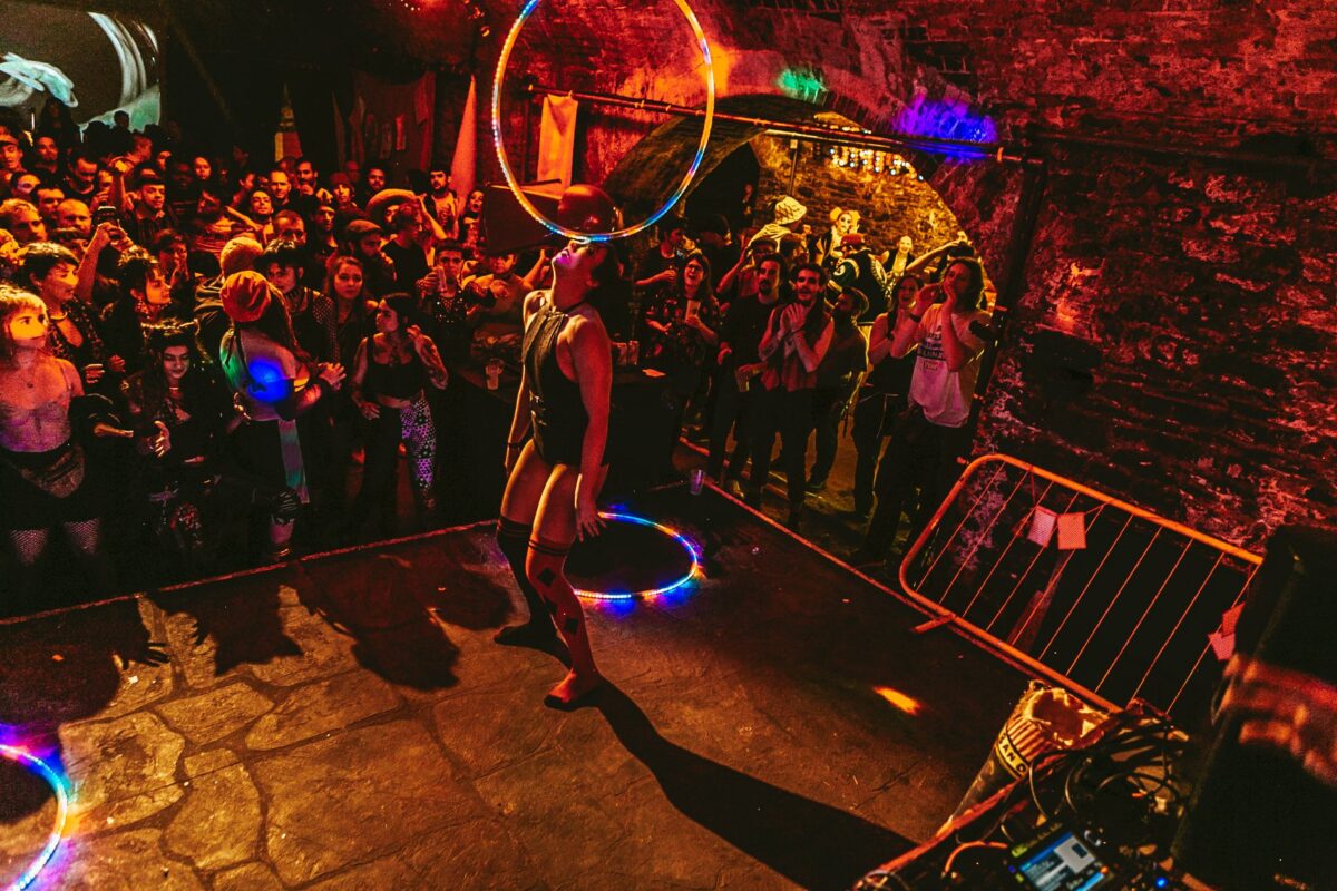 hoop performer surrounded by audience on stage