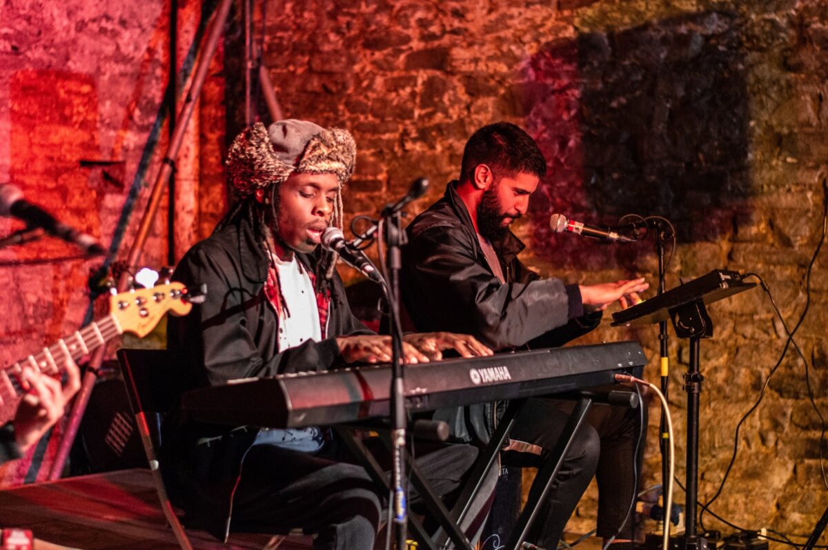 live musicians sat a keyboard singing