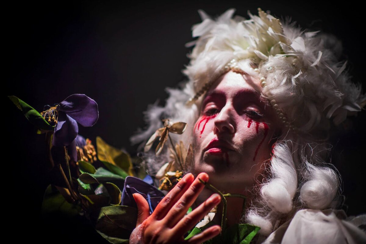 circus performer with wig and red tear drops