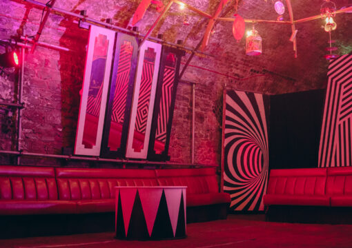 a photo of the decor and seating in tunnel 3 lit with red lighting.