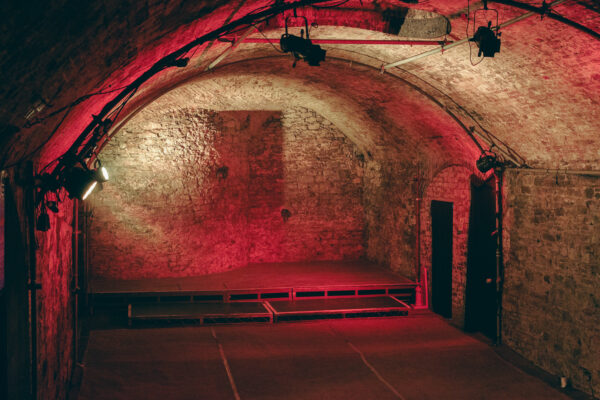 The stage in tunnel 4 lit by a red light.