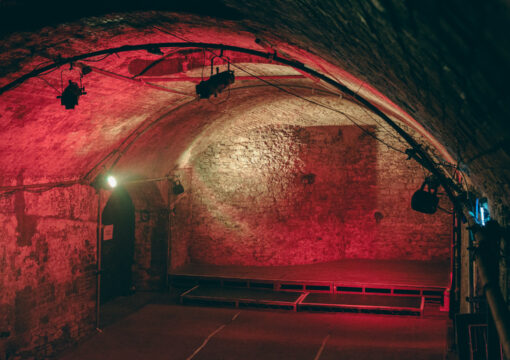 the whole of tunnel 4 as well as the stage lit by a red light.